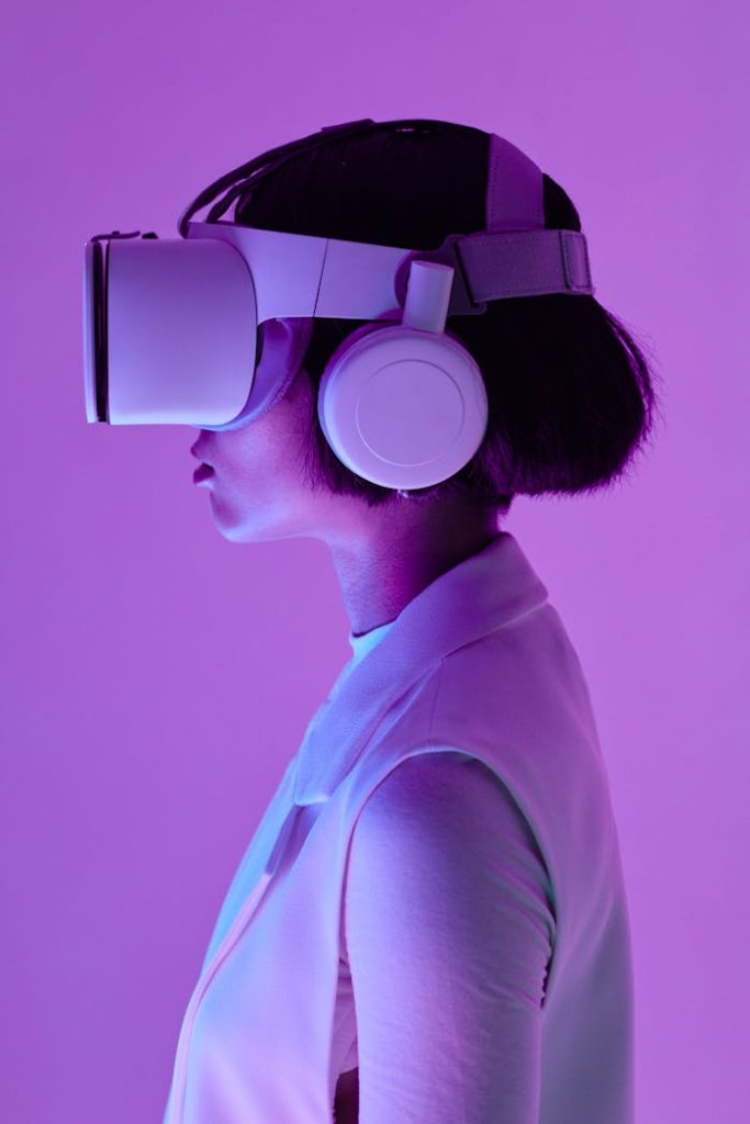 a-woman-using-virtual-goggles-8728382 Side profile of a woman wearing VR goggles in a studio with purple lighting, embodying future tech.